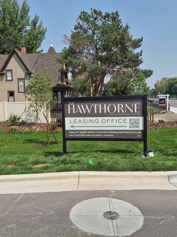 Hawthorne leasing office ACM sign in a full wood frame