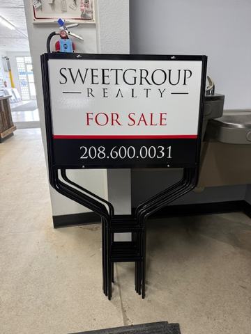 Sweetgroup Realty For Sale sign on a wire stand